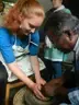 Tina using pottery wheel with teacher.