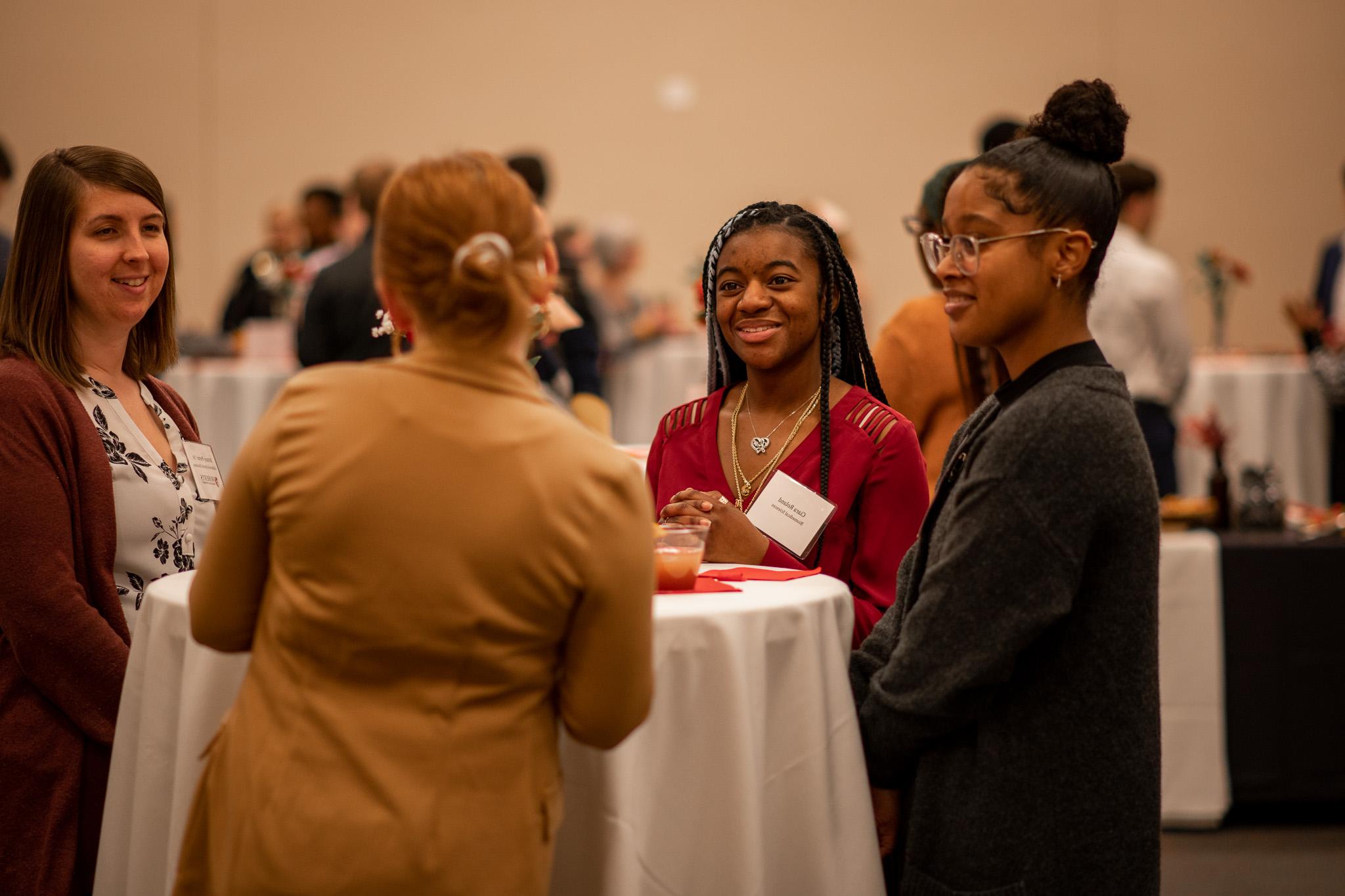 Roberts Wesleyan University students and mentors chat during a networking event.